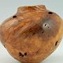This is a piece of Madrone burl, about 4 1/4" wide by 3 3/4" tall. This hollow form was turned to finished thickness while the wood was still green, then allowed to warp at will. (If left thicker, Madrone burl tends to crack.) Considering this piece was very smooth and symmetrical before it dried, it moved a remarkable amount, especially considering its small size.